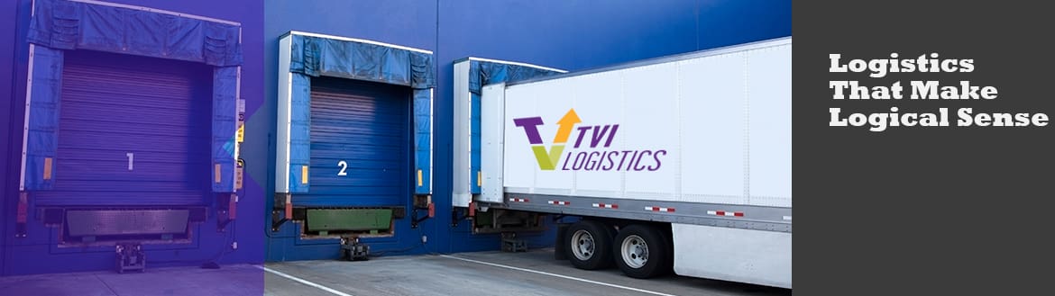 A white truck parked in front of a blue building.